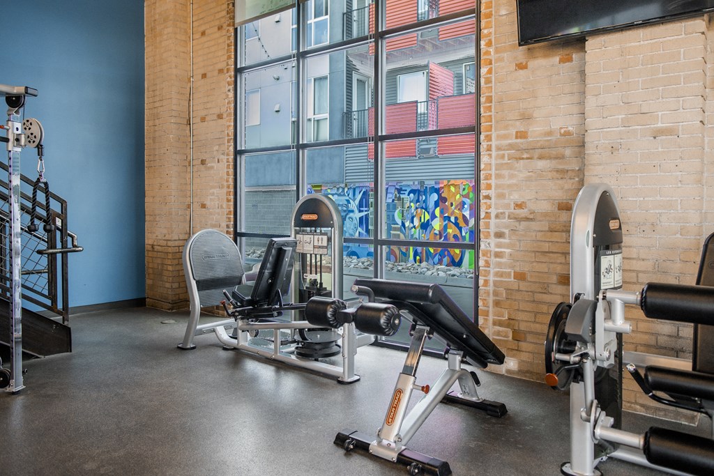 a gym with weights and a window
