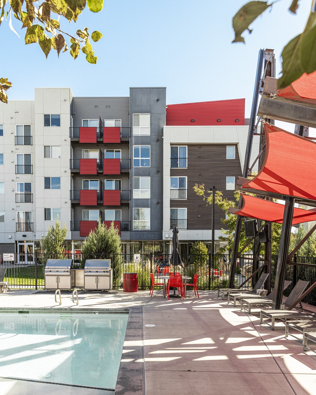 a swimming pool with a building in the background