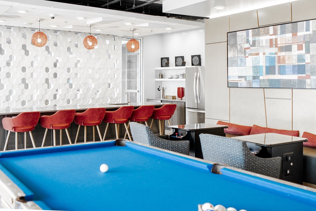 a pool table in a room with tables and chairs