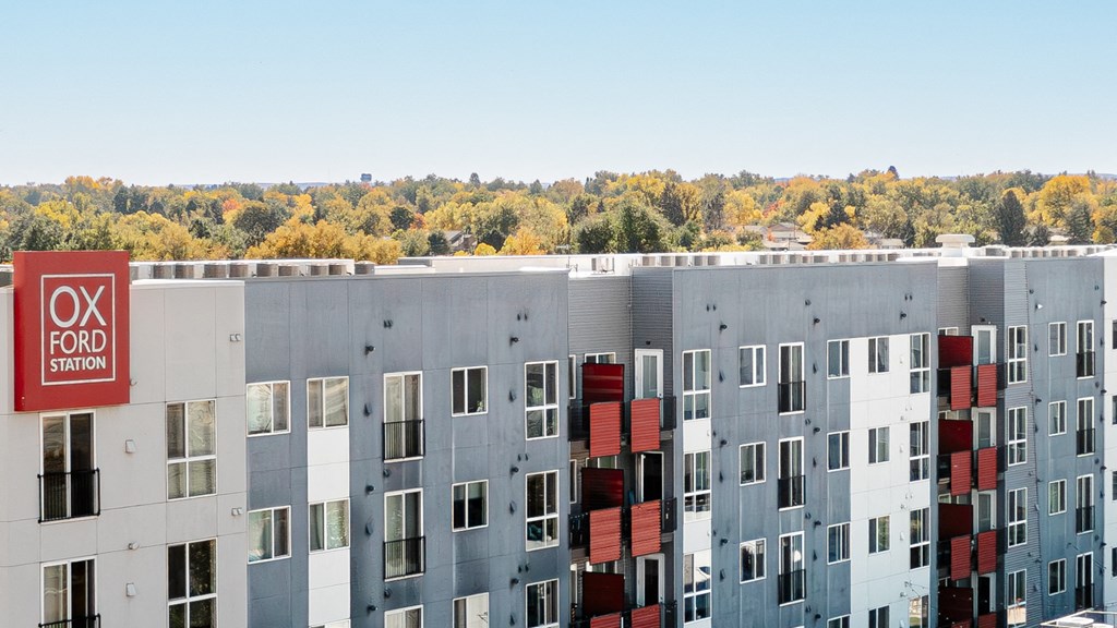 a view of an apartment building with a street sign