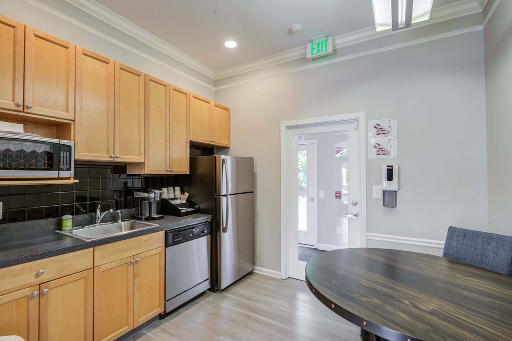 a kitchen with wooden cabinets and a stainless steel refrigerator