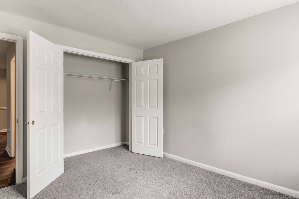 a bedroom with a closet and a door to a closet