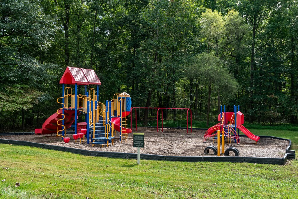 a playground with a swing set in a park