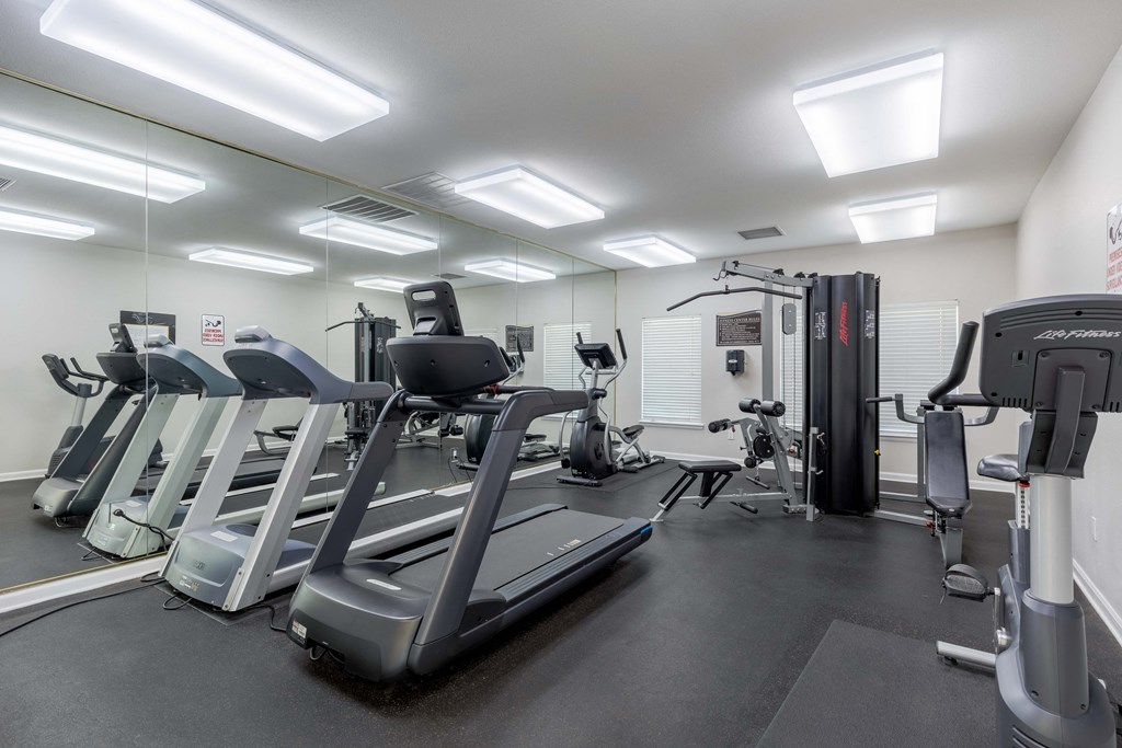 a gym with cardio machines and other fitness equipment