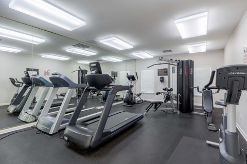 a gym with cardio machines and other fitness equipment