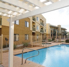 a swimming pool in front of an apartment building