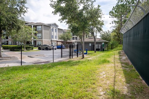 A view of a grassy area with a building in the background.