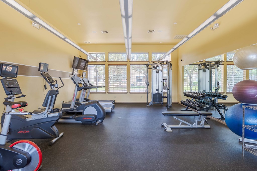 a gym with cardio machines and weights at the enclave at woodbury