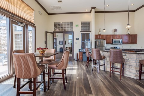 a kitchen and dining area with a table and chairs