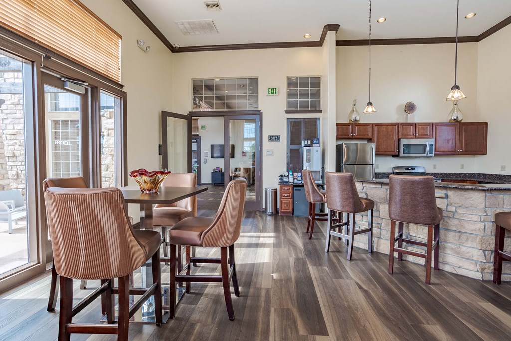 a kitchen and dining area with a table and chairs