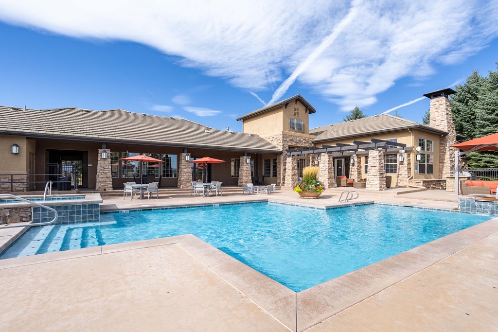 a swimming pool with a house in the background