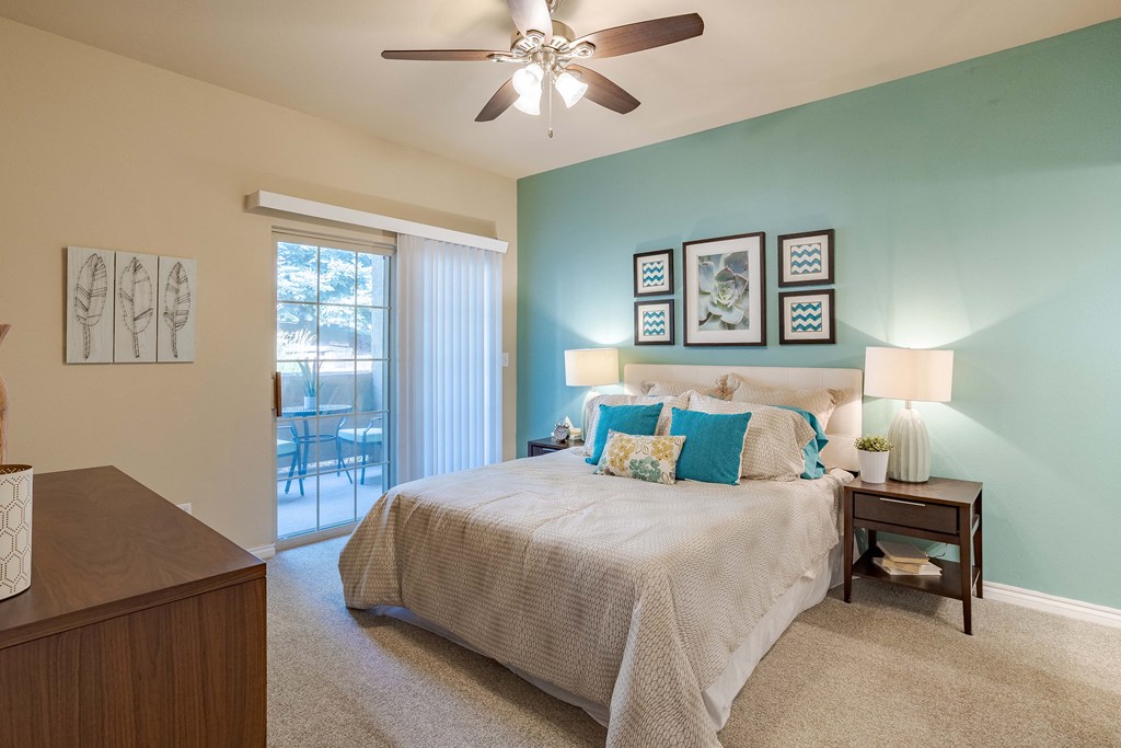 a bedroom with a large bed and a ceiling fan