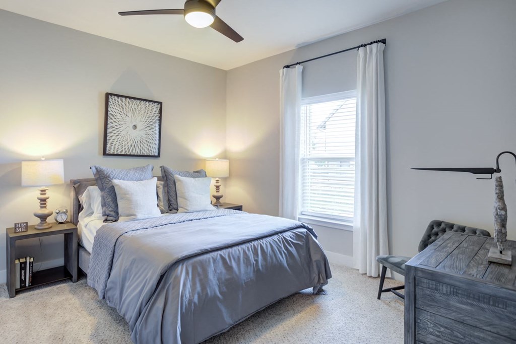 a bedroom with a bed and a ceiling fan