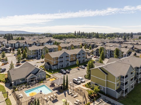 an aerial view of an apartment complex with a swimming pool