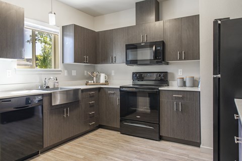 a kitchen with stainless steel appliances and wooden cabinets