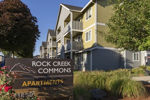 a apartments sign in front of a building