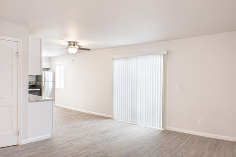 A spacious room with a ceiling fan and a cabinet.