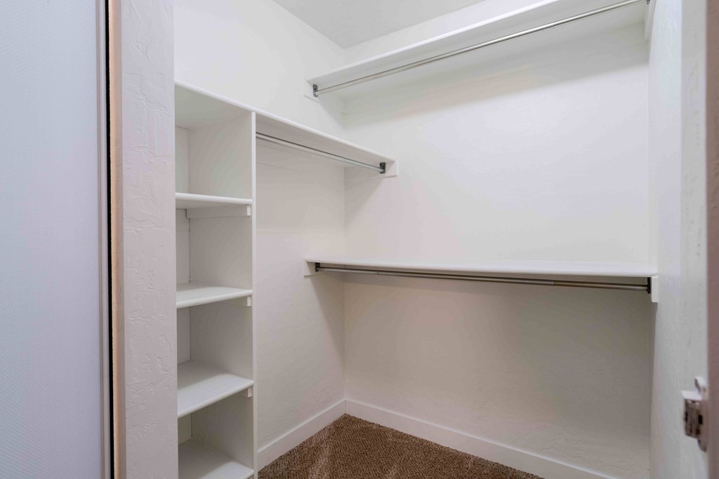 A walk-in closet with shelves.