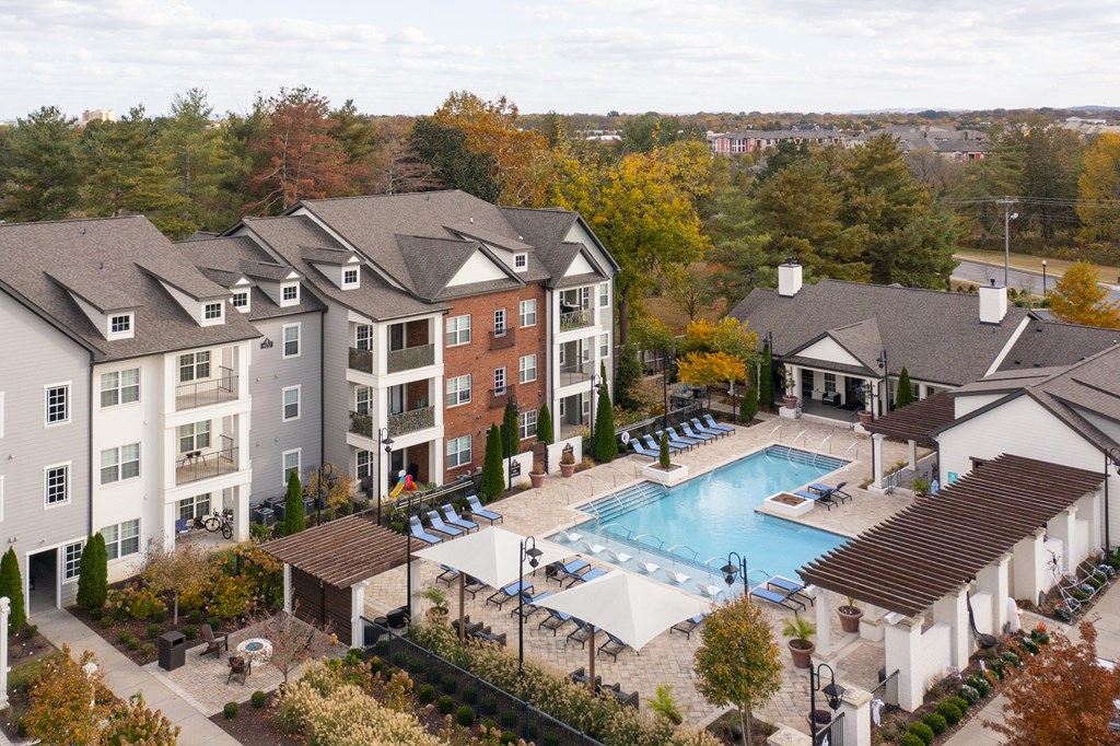 an aerial view of an apartment complex with a swimming pool