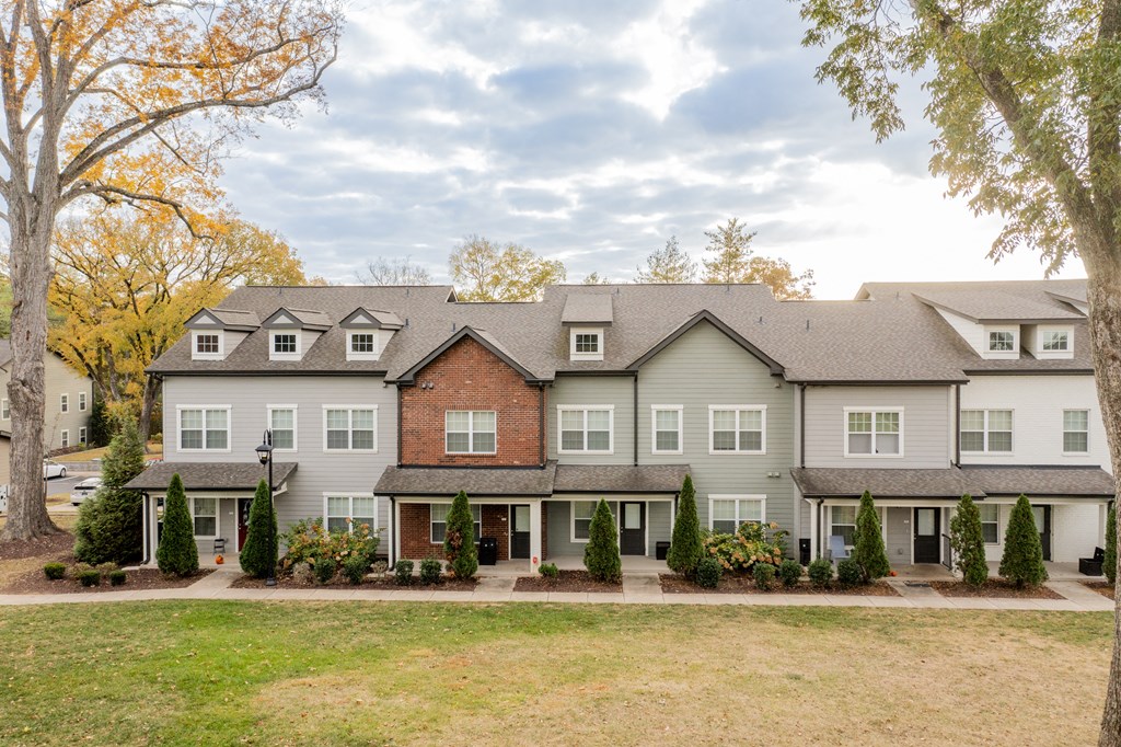the view of a large house with a yard in front of it