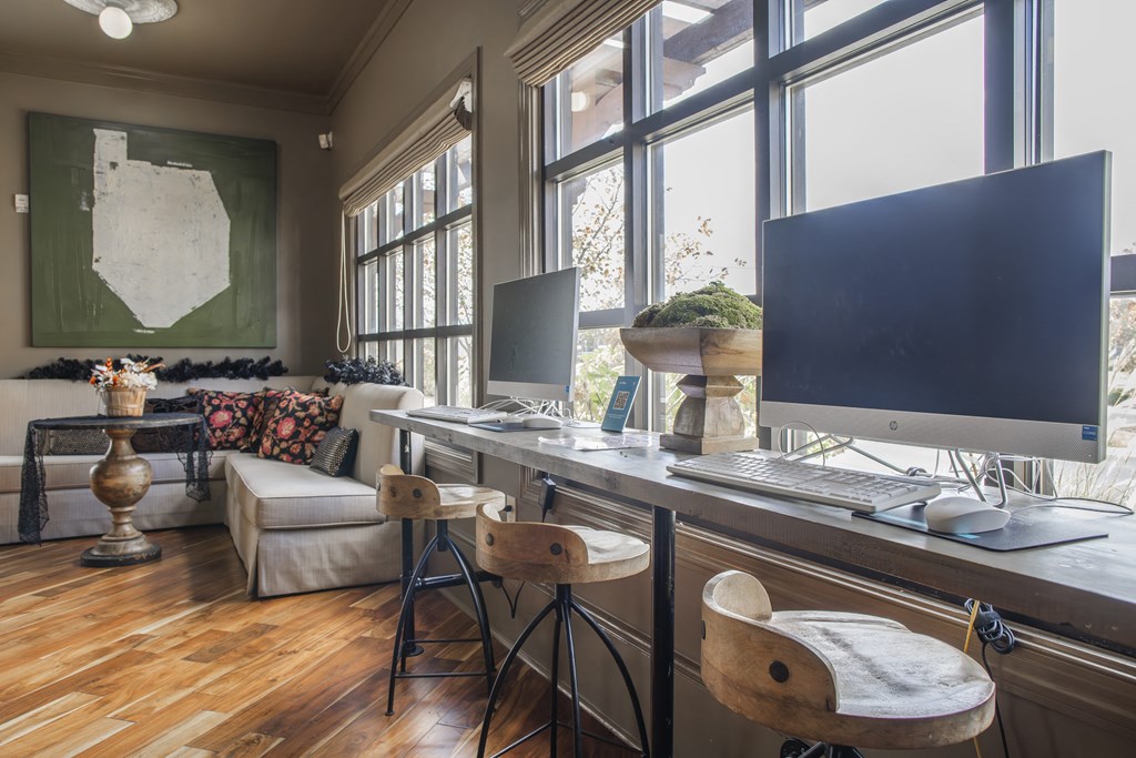 a home office with two computer monitors on a desk