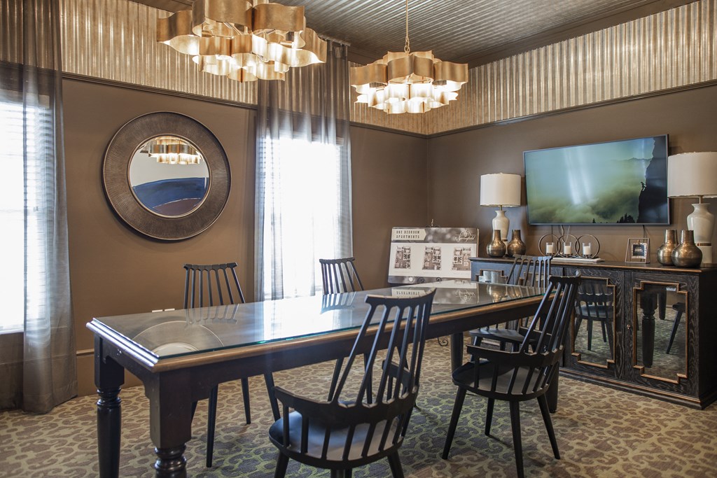 a dining room with a table and chairs and a television