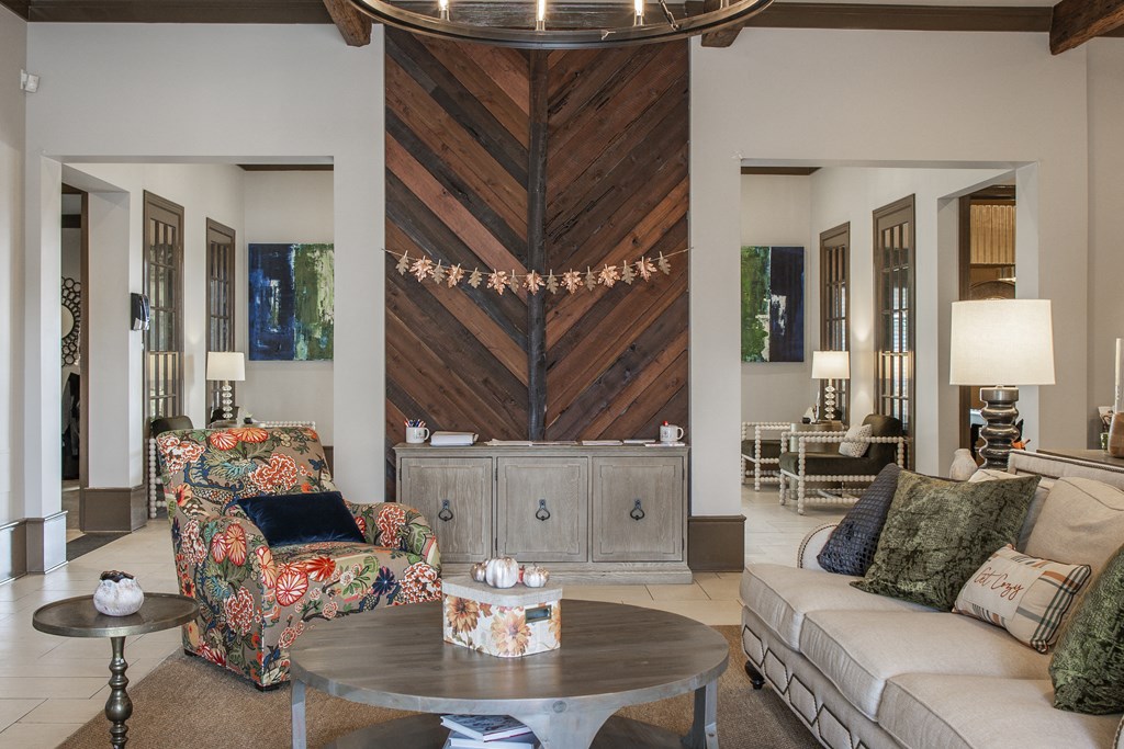 a living room with a couch and chairs and a table
