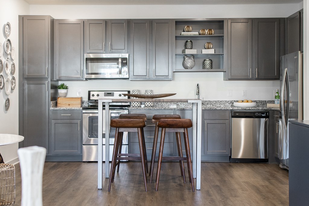 a kitchen with stainless steel appliances and gray cabinets