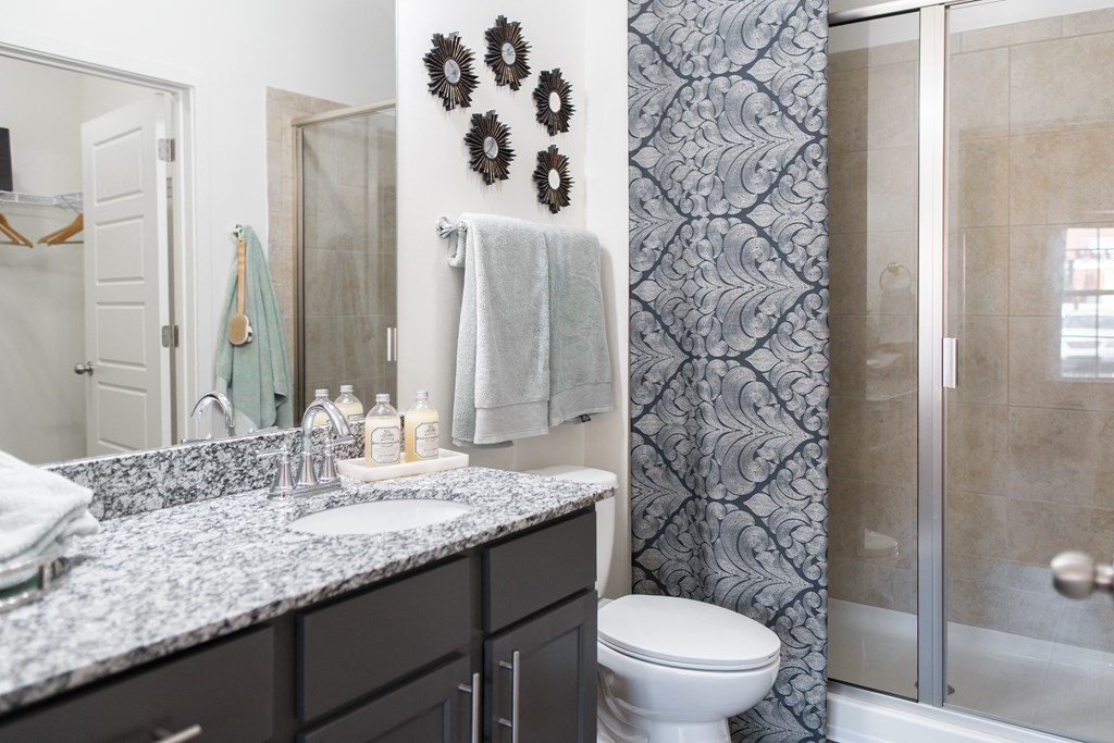 a bathroom with a sink and a toilet and a shower
