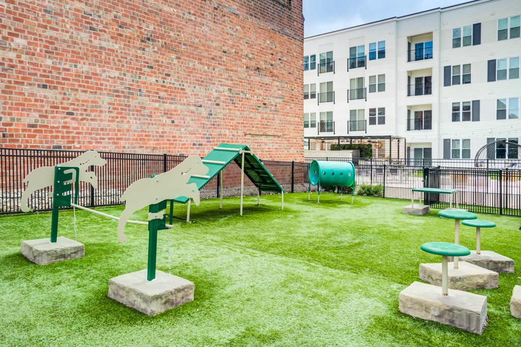 A playground with a slide, swings, and tables.