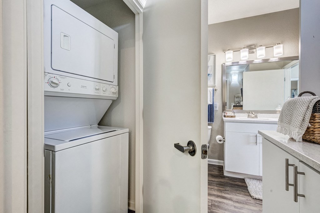 an open door to a laundry room with a washer and dryer