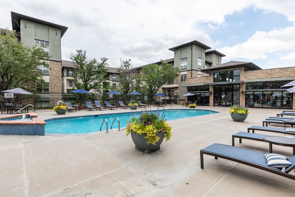 A pool area with a bench and a planter.