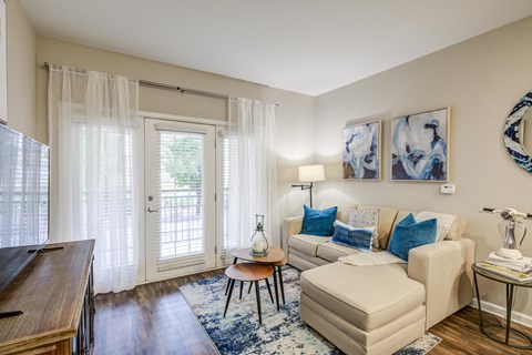 an open living room with a couch and a door to a patio