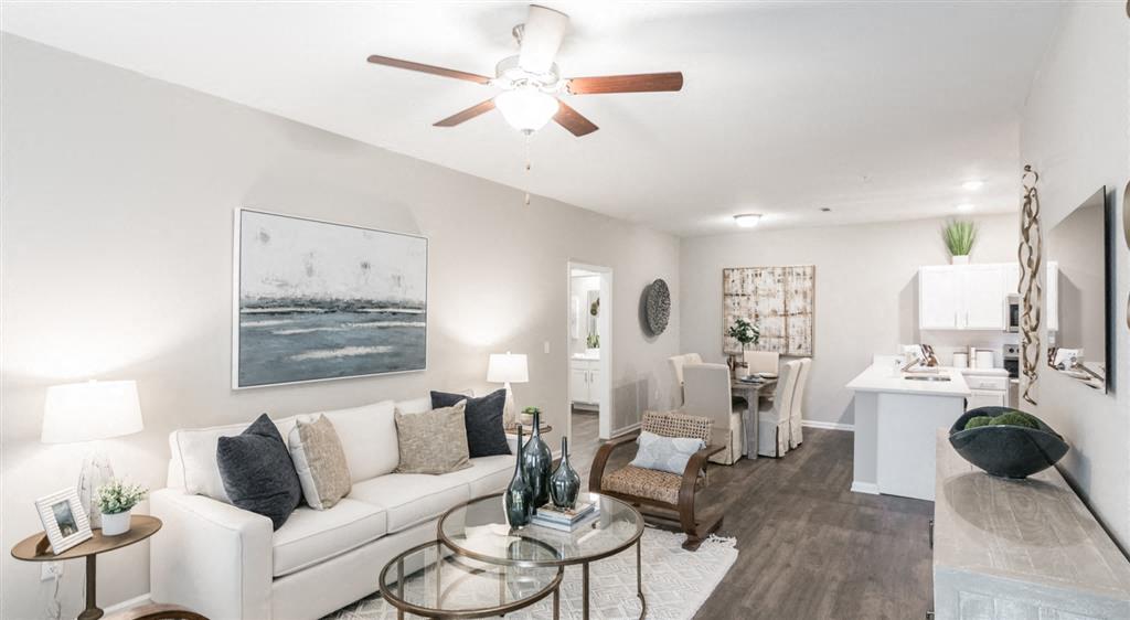 a living room with a couch and a ceiling fan