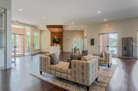 A spacious living room with a patterned sofa and a wooden coffee table.