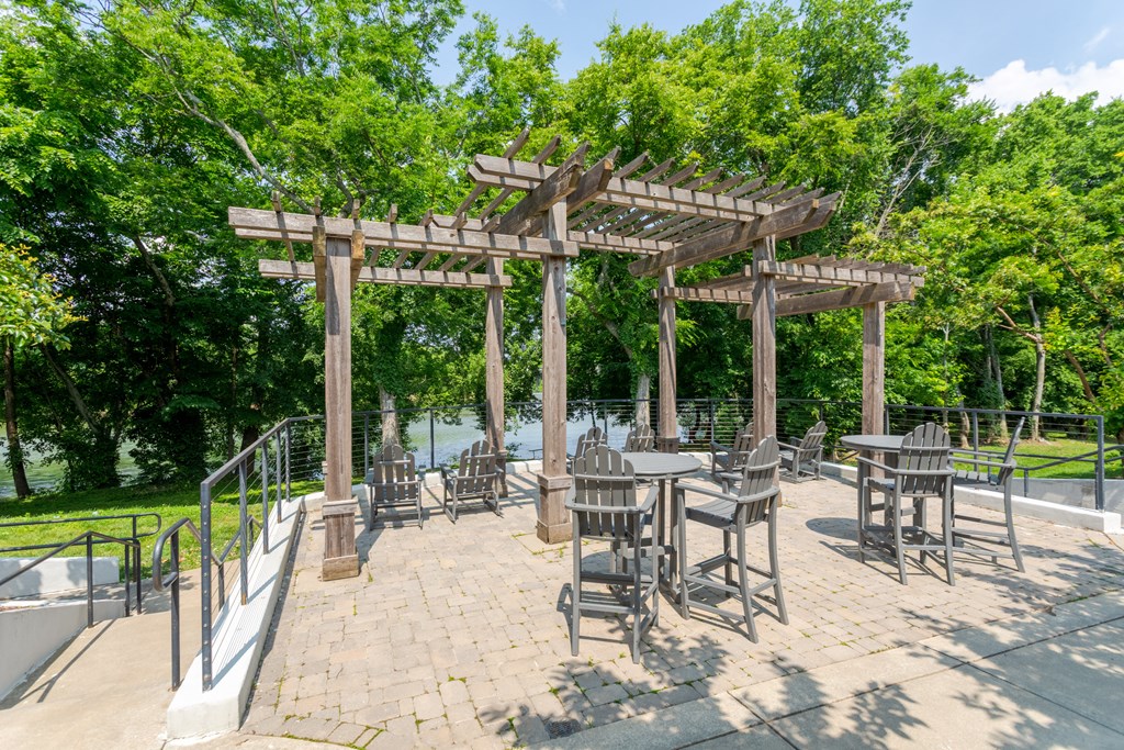 Outdoor pergola and lounge area with a river view