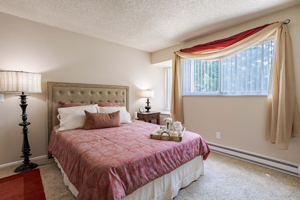 a bedroom with a bed and a window