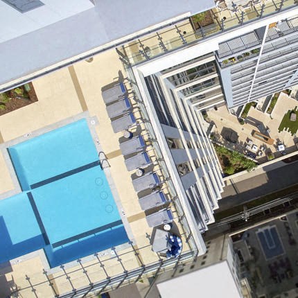 an aerial view of a swimming pool on top of a building