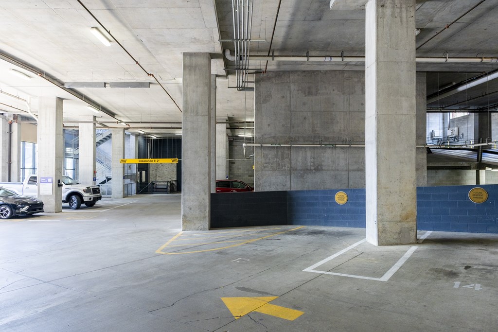 A parking garage with a yellow arrow on the ground.