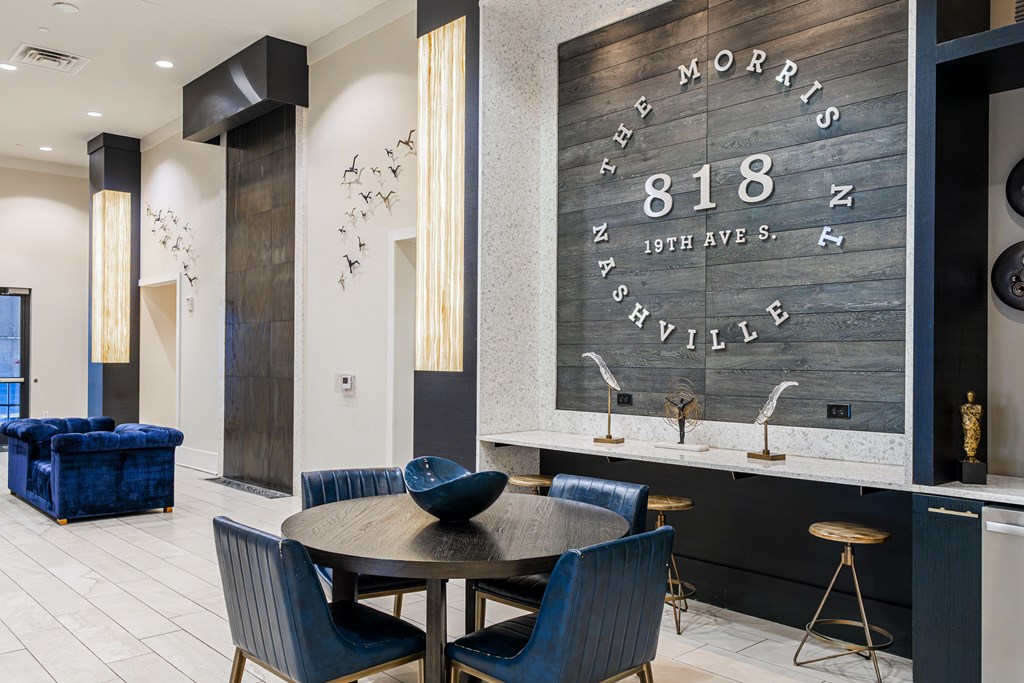 A modern dining area with a wooden sign that reads "The Morris Nashville 818 North 19th Ave S."
