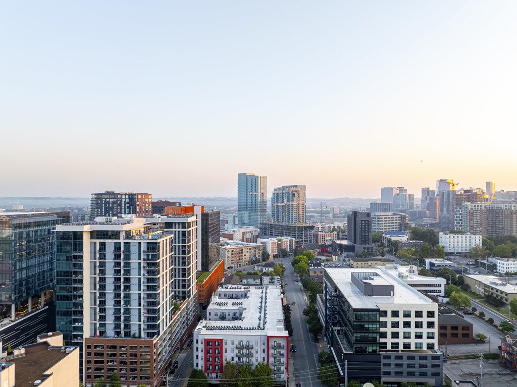 A cityscape with buildings of various heights and designs.