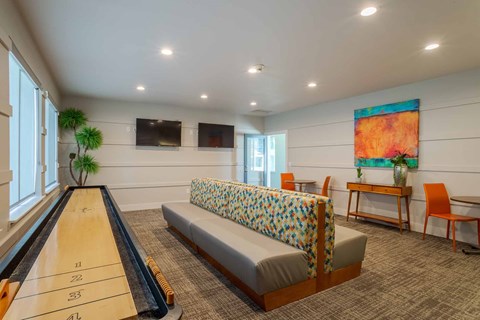A game room with shuffleboard.