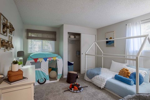 A child's bedroom with a bunk bed and a play tent.