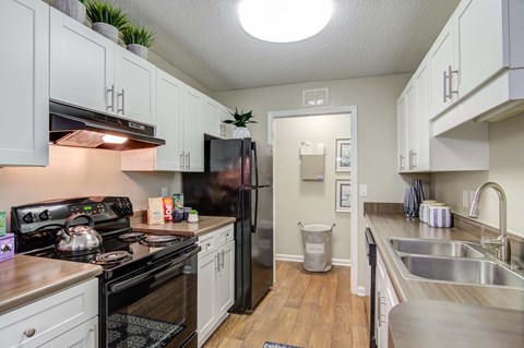 a kitchen with stainless steel appliances and white cabinets