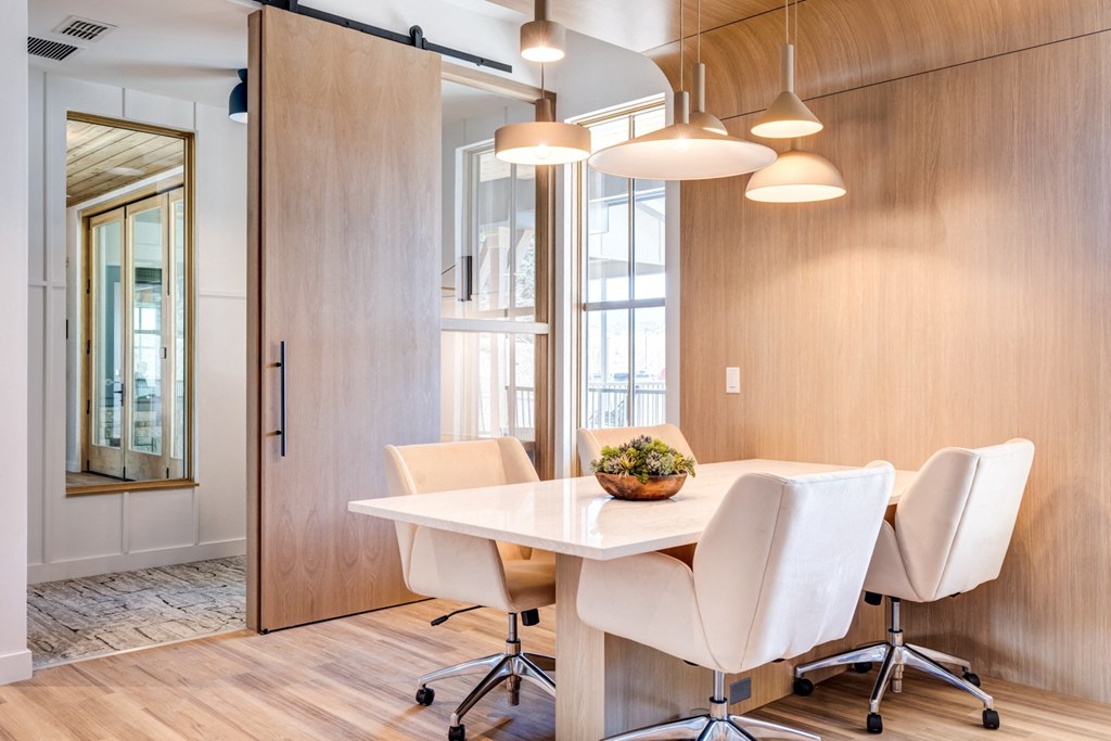 a dining room with a white table and chairs
