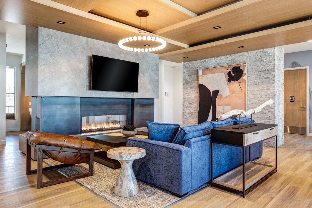 a living room with a blue couch and a fireplace