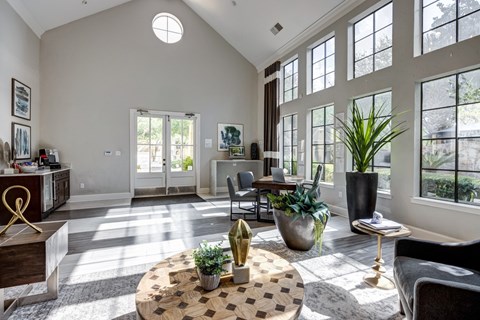 A sunny living room with a checkered table in the middle.
