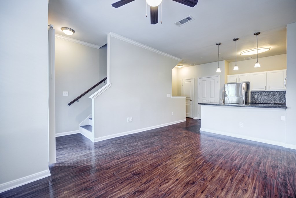 A room with a wooden floor and a ceiling fan.
