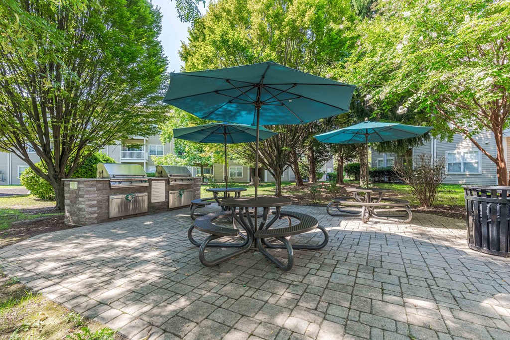 a picnic area with tables and umbrellas