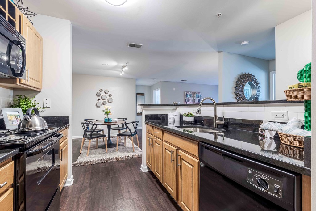a kitchen with a sink and a stove and a table